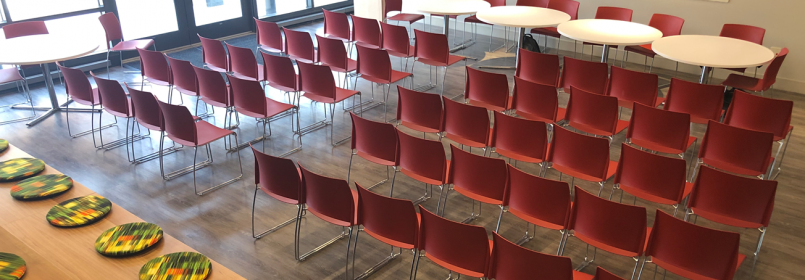 Photo of event setup with rows of chairs in BNAACC space